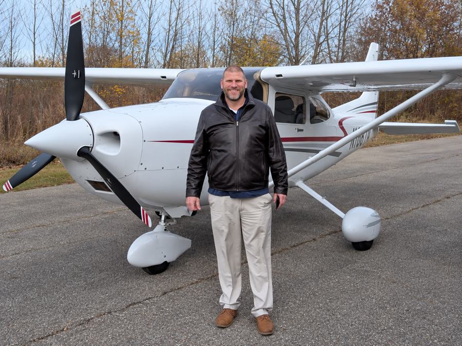 Jason P. Meesseman standing beside his Cessna.